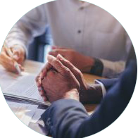 Two people in the process of signing a contract with paper and a pen